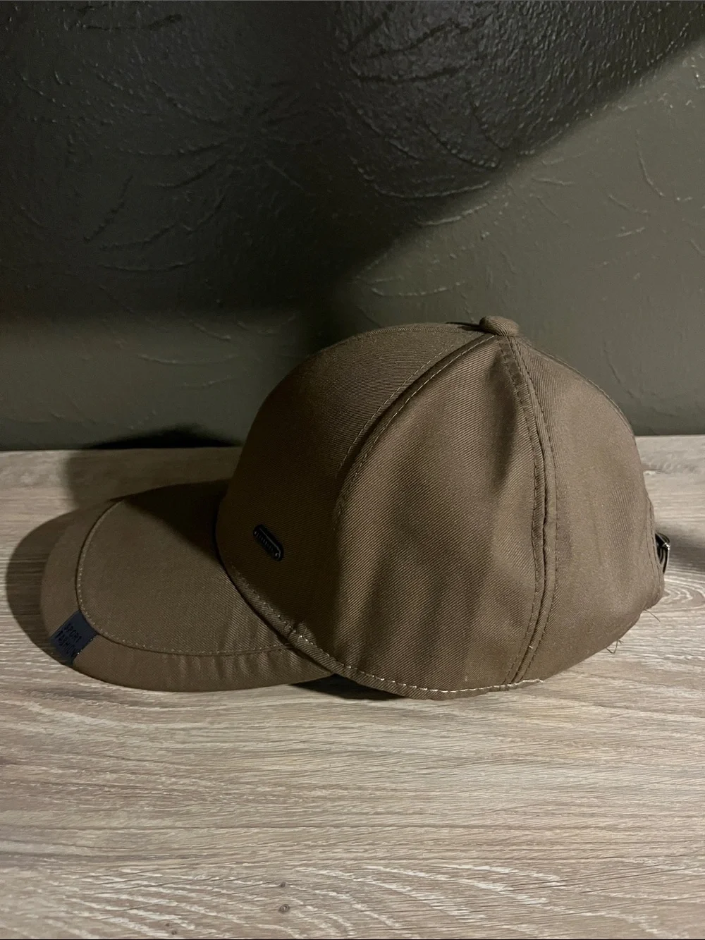Brown Baseball Cap With Small Logo on Brim That Says “Sport Fashion”